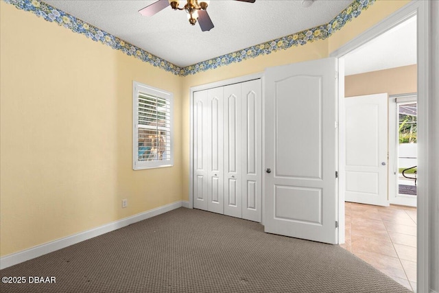 36 Allenwood Look, Ormond Beach, FL 32174 - unfurnished bedroom with multiple windows, a textured ceiling, a closet, carpet floors, and a ceiling fan