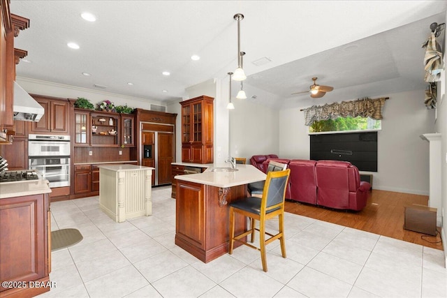 36 Allenwood Look, Ormond Beach, FL 32174 - kitchen with stainless steel appliances, extractor fan, open floor plan, light tile patterned floors, and a ceiling fan
