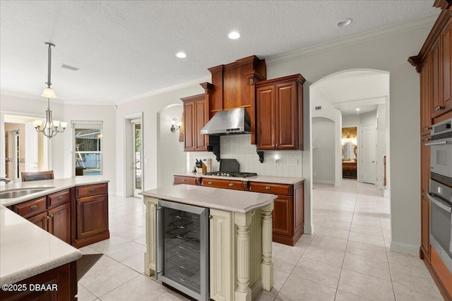 36 Allenwood Look, Ormond Beach, FL 32174 - kitchen featuring wine cooler, arched walkways, exhaust hood, light countertops, and light tile patterned floors