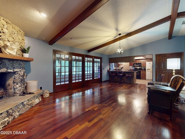 108 Dee St, New Smyrna Beach, FL 32168 - living room with a fireplace, wood finished floors, and a textured ceiling