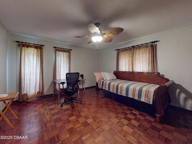 108 Dee St, New Smyrna Beach, FL 32168 - bedroom with multiple windows, baseboards, a textured ceiling, and a ceiling fan