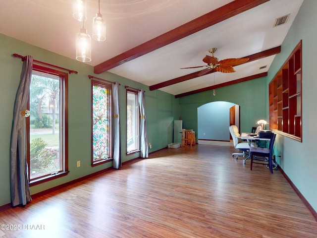 108 Dee St, New Smyrna Beach, FL 32168 - living area with arched walkways, wood finished floors, baseboards, and ceiling fan