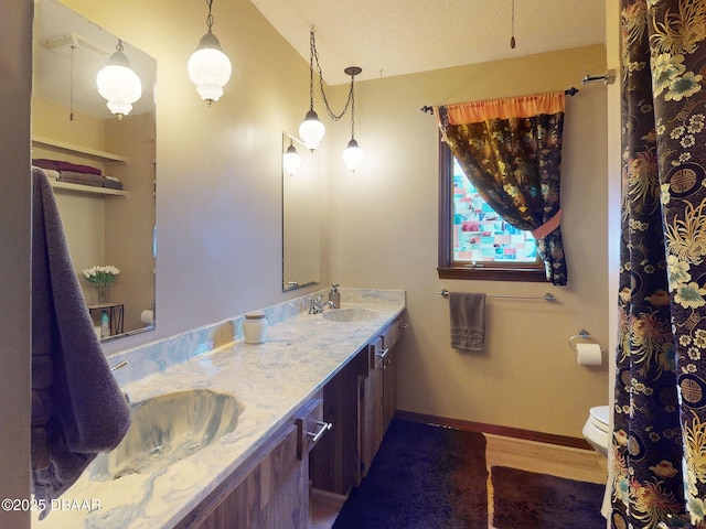 108 Dee St, New Smyrna Beach, FL 32168 - full bathroom featuring toilet, wood finished floors, double vanity, lofted ceiling, and baseboards