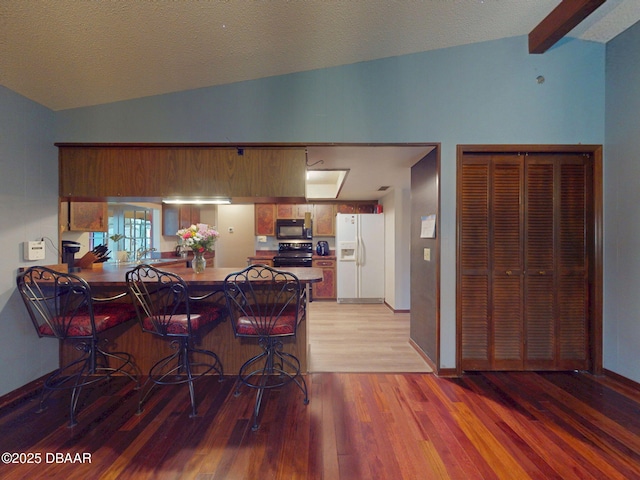 108 Dee St, New Smyrna Beach, FL 32168 - dining area featuring vaulted ceiling, light wood-style flooring, and baseboards