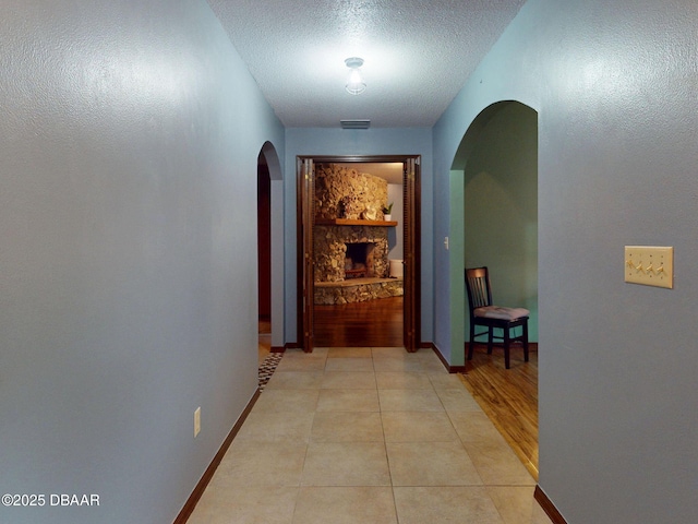 108 Dee St, New Smyrna Beach, FL 32168 - corridor with arched walkways, a textured ceiling, and baseboards