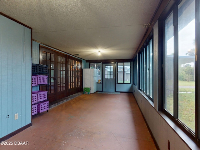 108 Dee St, New Smyrna Beach, FL 32168 - unfurnished sunroom featuring plenty of natural light and a textured ceiling