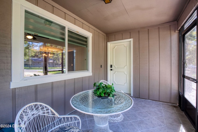 unfurnished sunroom with a wealth of natural light and ceiling fan