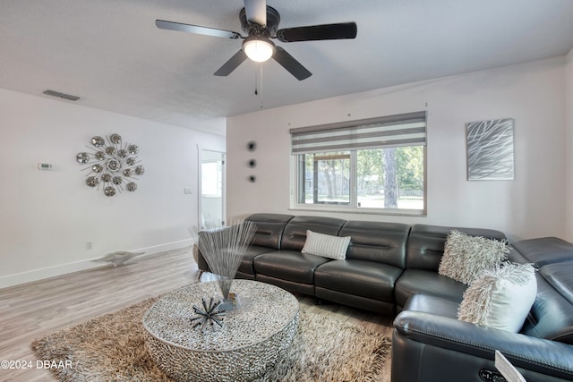 living room with ceiling fan and light wood-type flooring