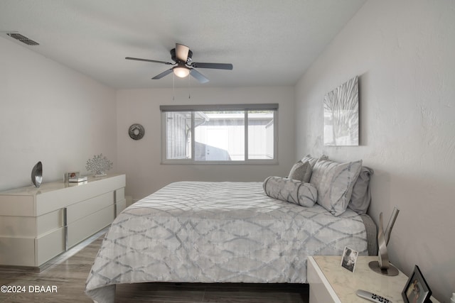 bedroom with hardwood / wood-style flooring and ceiling fan