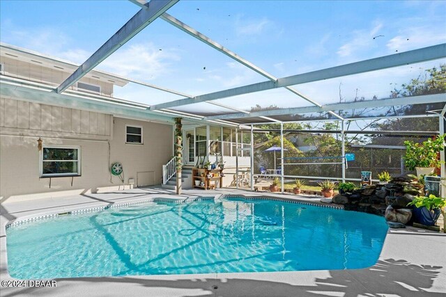 14 Woodlake Dr, Port Orange, FL 32129 - swimming pool featuring a patio area and glass enclosure