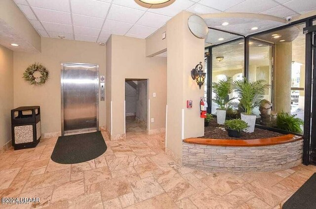 3501 S Atlantic Ave Unit 503, Daytona Beach, FL 32118 - community lobby featuring a paneled ceiling and a surveillance system