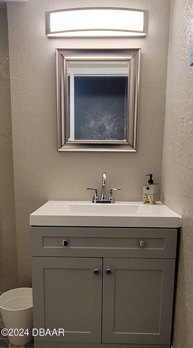 3501 S Atlantic Ave Unit 503, Daytona Beach, FL 32118 - bathroom featuring vanity, toilet, and a textured wall