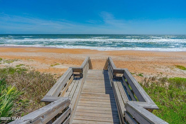 view of community with view of water and beach