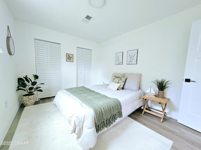 bedroom featuring wood finished floors and baseboards