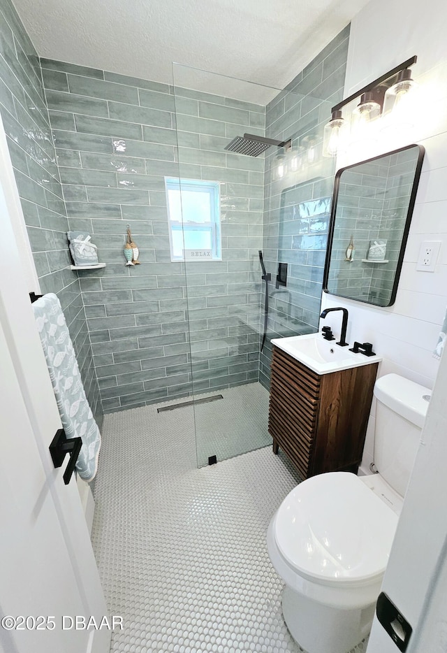 full bathroom with a walk in shower, toilet, vanity, and tile patterned floors