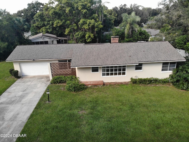 view of front of property with a front lawn and a garage