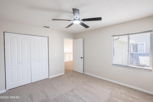 15 Misners Trl, Ormond Beach, FL 32174 - unfurnished bedroom featuring carpet flooring, a closet, baseboards, and a ceiling fan