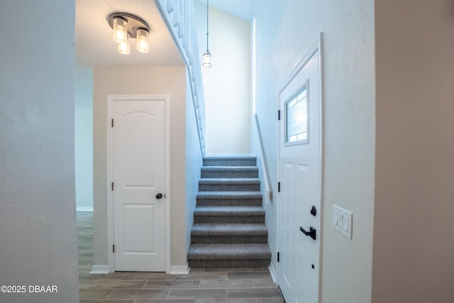 15 Misners Trl, Ormond Beach, FL 32174 - staircase with wood tiled floors, baseboards, and a textured wall