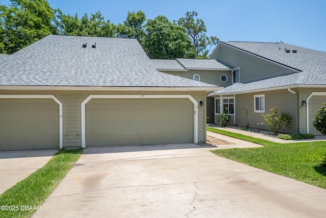 15 Misners Trl, Ormond Beach, FL 32174 - view of front of home featuring roof with shingles, concrete driveway, and a garage