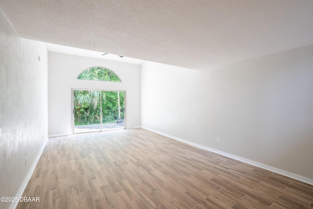 15 Misners Trl, Ormond Beach, FL 32174 - unfurnished room with wood finished floors, baseboards, and a textured ceiling