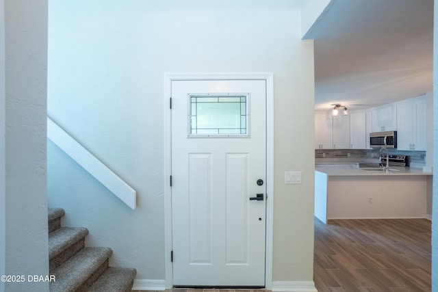 15 Misners Trl, Ormond Beach, FL 32174 - foyer entrance with wood finished floors and stairs