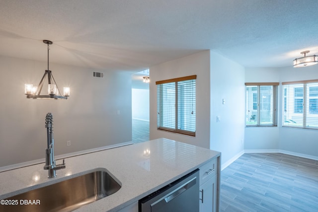 15 Misners Trl, Ormond Beach, FL 32174 - kitchen featuring a sink, stainless steel dishwasher, plenty of natural light, and decorative light fixtures