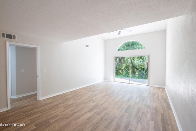 15 Misners Trl, Ormond Beach, FL 32174 - empty room with wood finished floors, baseboards, a ceiling fan, and a textured ceiling