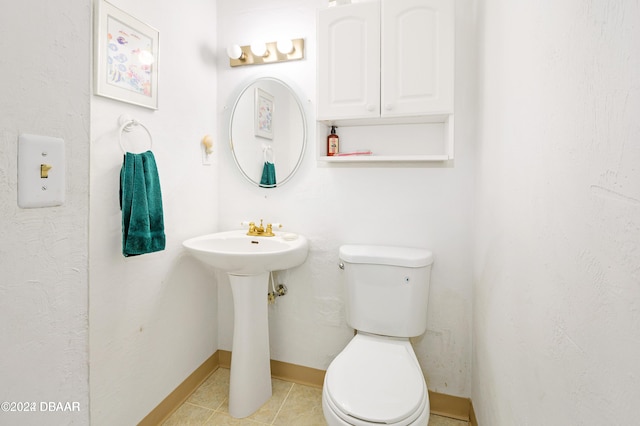 bathroom with tile patterned flooring and toilet