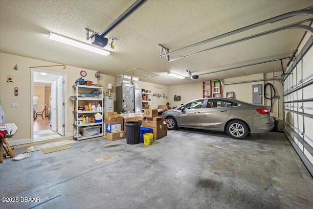 garage with electric panel and a garage door opener