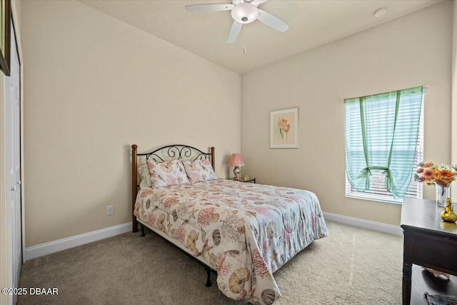 carpeted bedroom with ceiling fan and baseboards