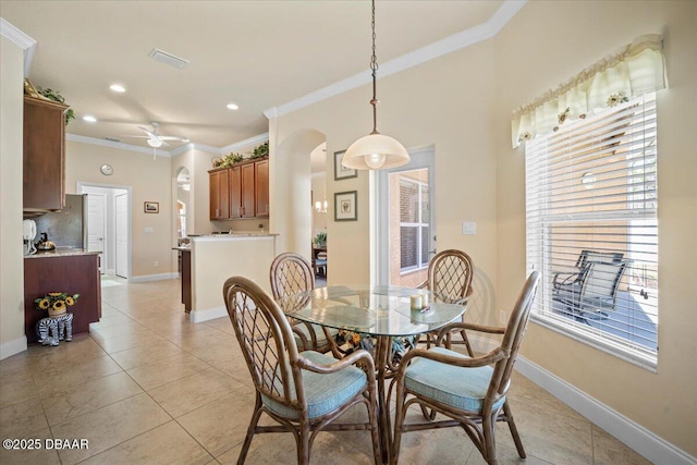 dining area featuring light tile patterned floors, ceiling fan, ornamental molding, and baseboards