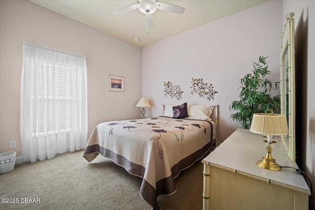 carpeted bedroom featuring a ceiling fan, vaulted ceiling, and baseboards