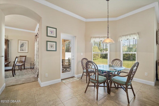 dining space featuring arched walkways, baseboards, light tile patterned flooring, and crown molding