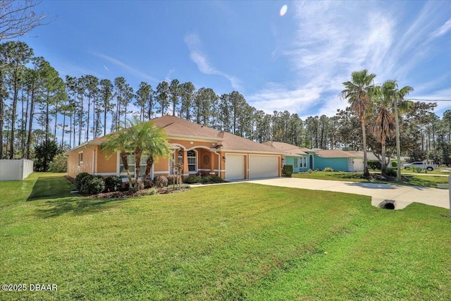 view of front of house with a garage, driveway, fence, and a front yard