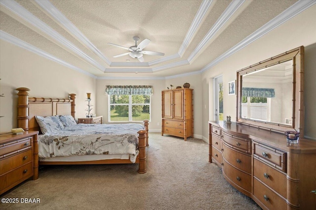 bedroom featuring ceiling fan, a textured ceiling, light carpet, a tray ceiling, and crown molding