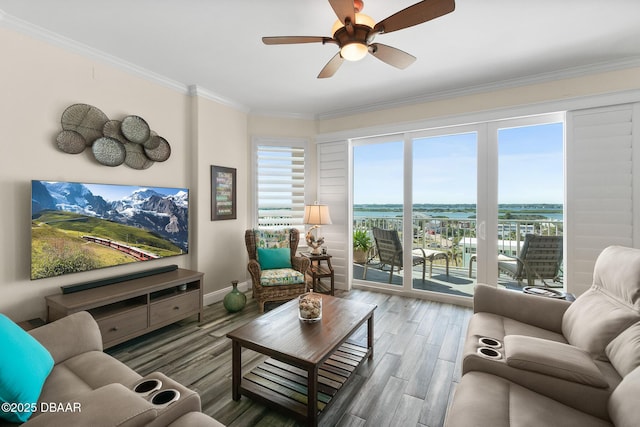 living room with hardwood / wood-style flooring, ceiling fan, and ornamental molding