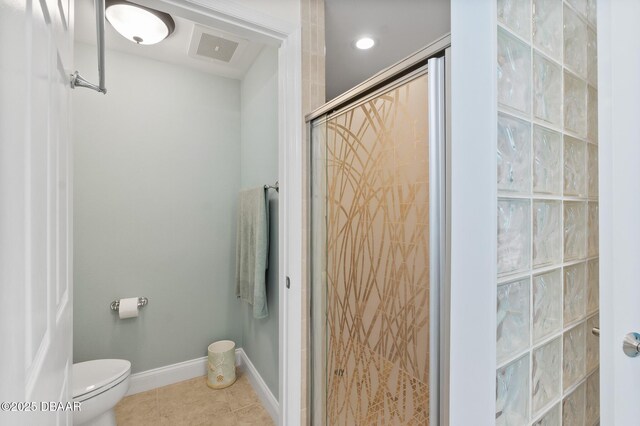 bathroom featuring toilet, an enclosed shower, and tile patterned flooring