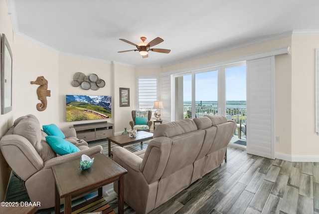 living room with ceiling fan and ornamental molding