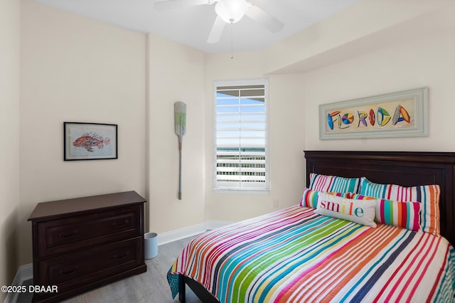 bedroom with ceiling fan and light hardwood / wood-style flooring