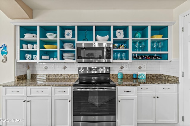 kitchen featuring white cabinets, stainless steel appliances, and tasteful backsplash