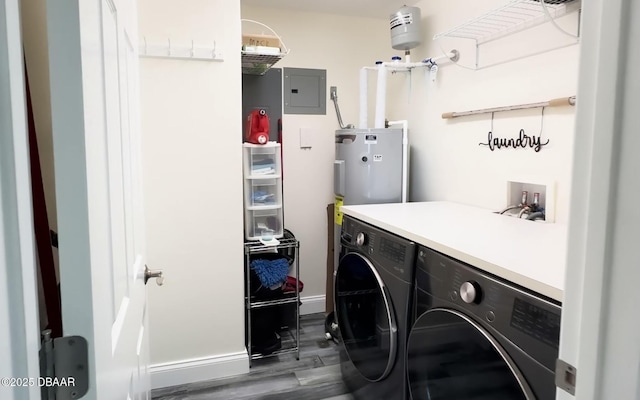 clothes washing area featuring washer and dryer, electric water heater, dark hardwood / wood-style floors, and electric panel