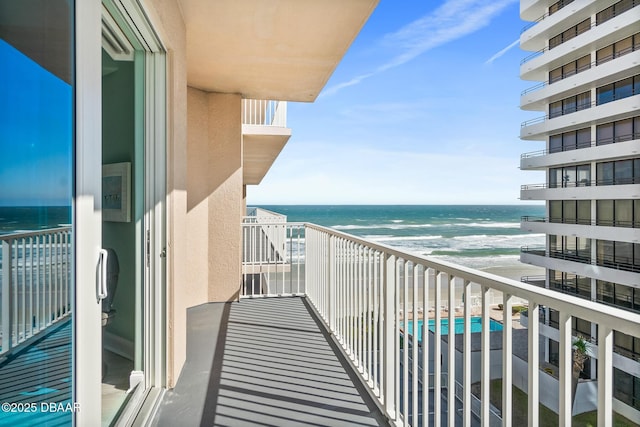 balcony with a beach view and a water view