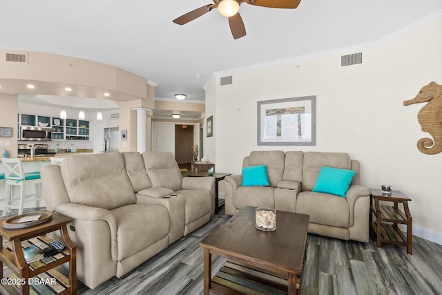 living room with sink, ornamental molding, ceiling fan, and dark hardwood / wood-style floors