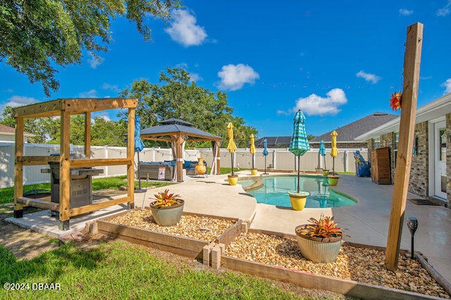 view of swimming pool featuring a patio and a gazebo