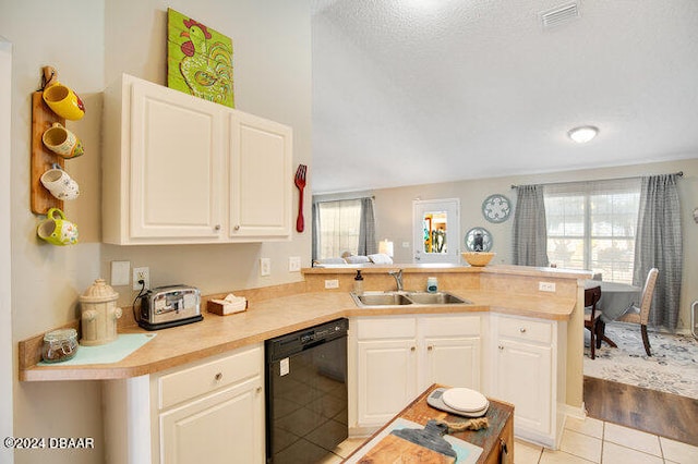 kitchen featuring light hardwood / wood-style floors, sink, kitchen peninsula, a textured ceiling, and black dishwasher