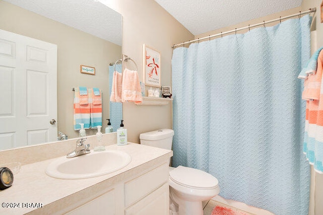 bathroom with toilet, vanity, and a textured ceiling