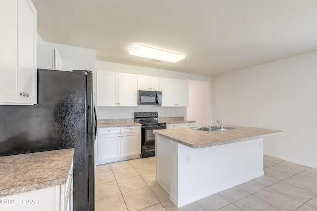 kitchen with a kitchen island with sink, black appliances, light tile patterned floors, white cabinets, and sink