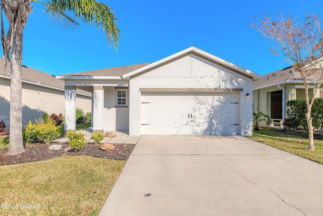 ranch-style house featuring a front yard and a garage