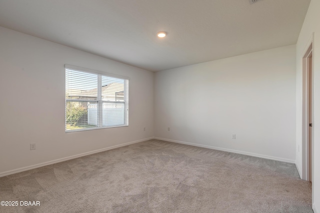 spare room with light colored carpet