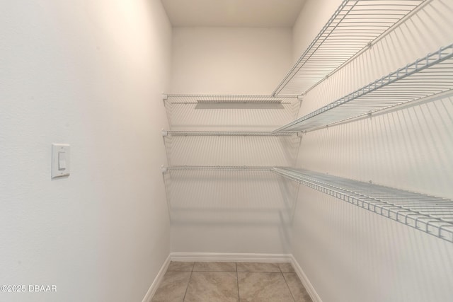 spacious closet featuring tile patterned flooring